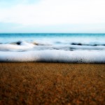 A close up of the sea and sand